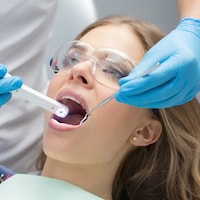 Woman having general dentistry with the aid of an intraoral camera