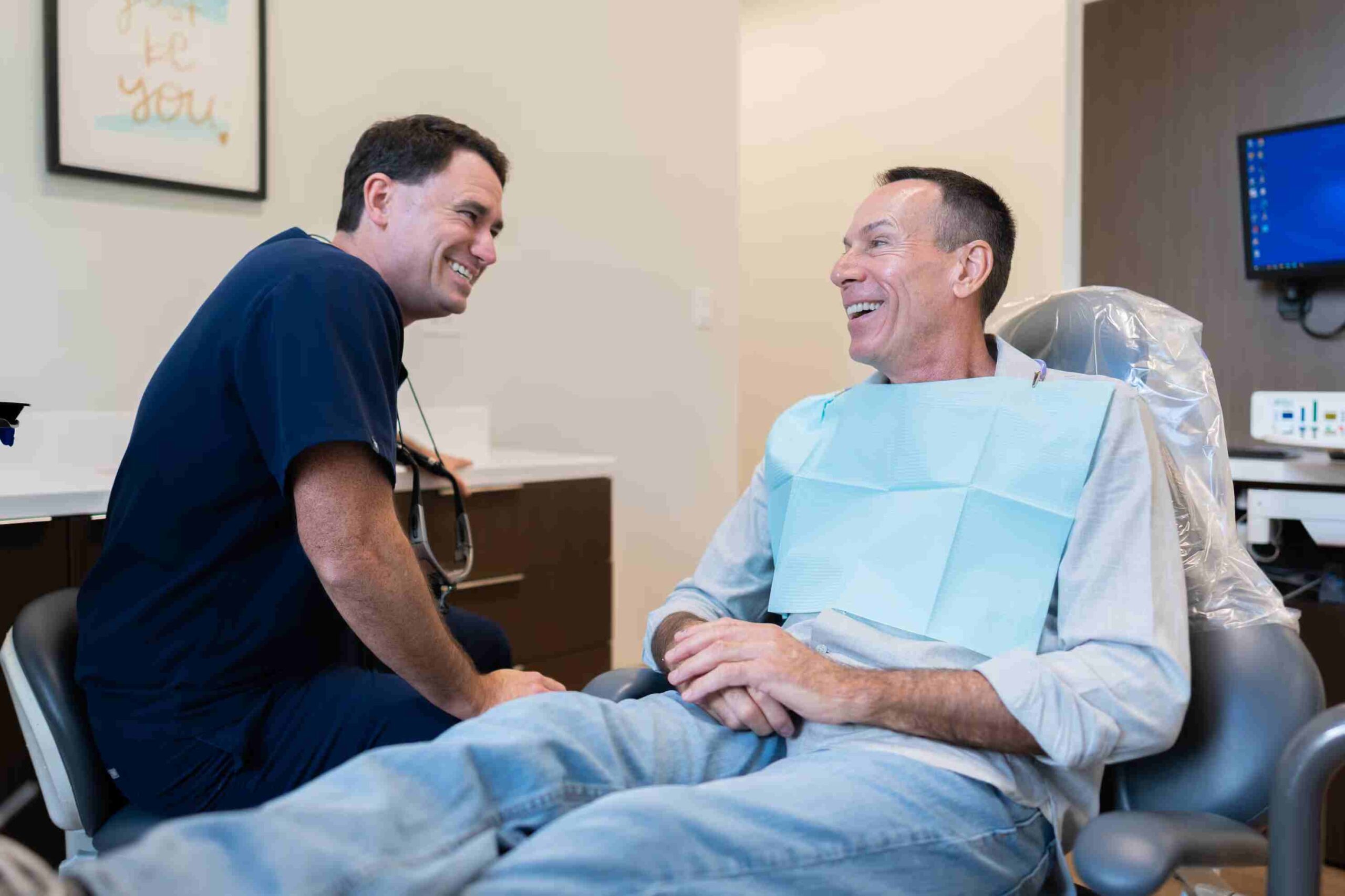 Dr. Sean Owens shaking hands with a patient at Kidder Owens Dental
