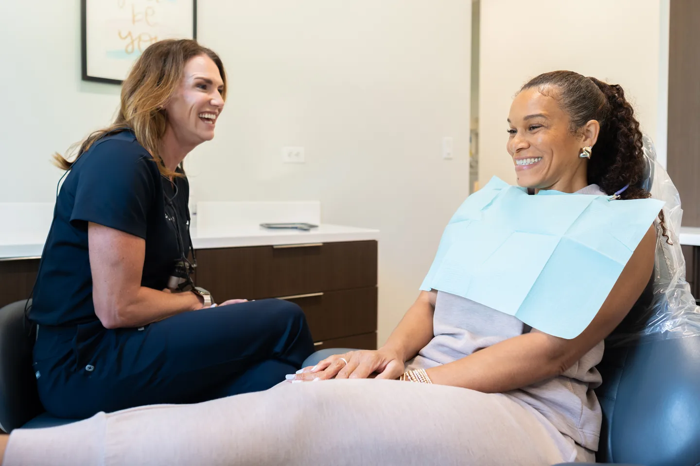 Kidder Owens Dental hygienist talking with a patient during a dental visit