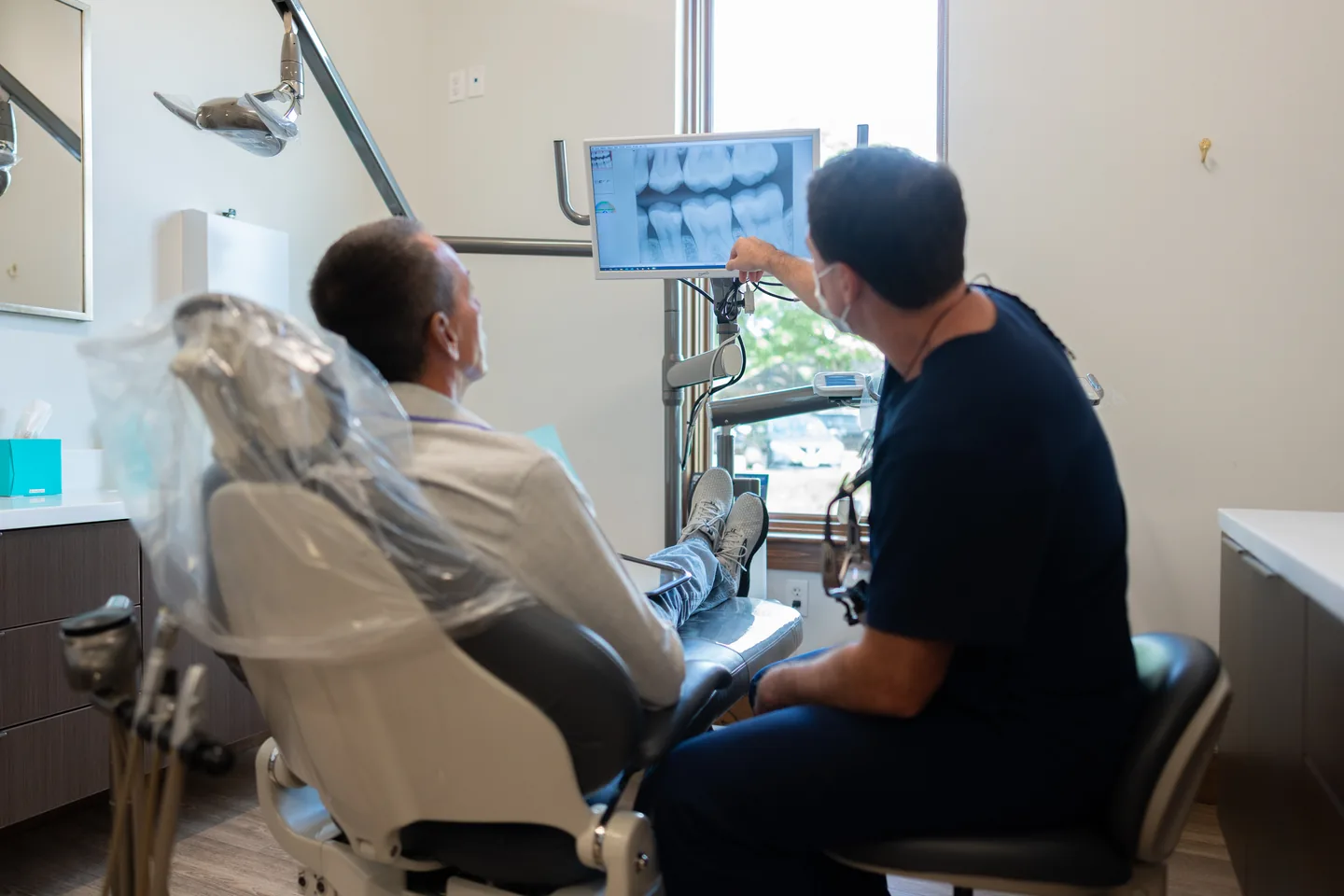 Kidder Owens Dental dentist reviewing digital dental x-rays with a patient