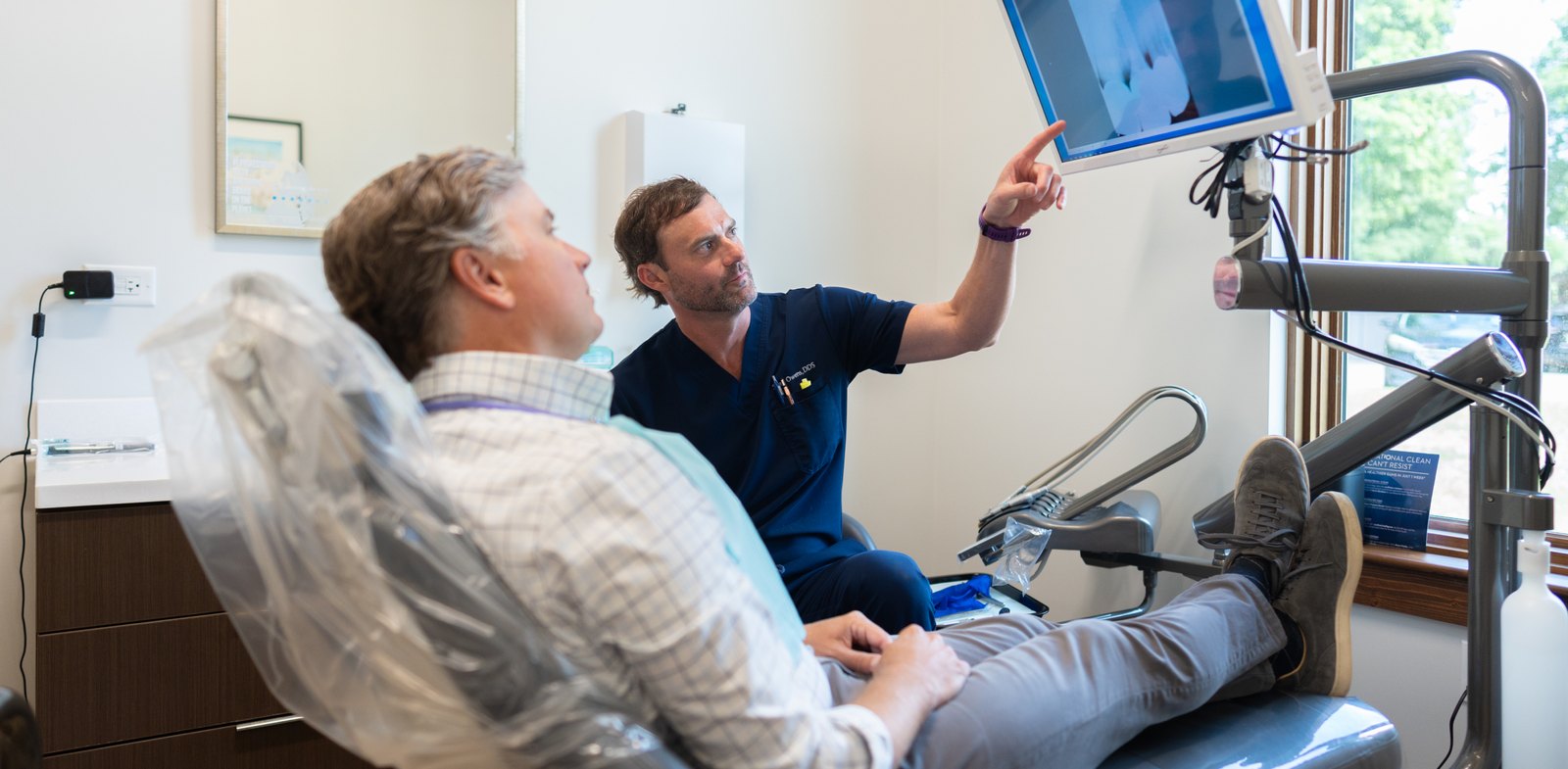 Dr. Sean Owens with a single tooth implant patient at Kidder Owens Dental in Baton Rouge